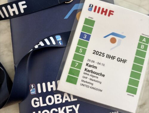 A photo of my IIHF accreditation and Global Hockey Forum booklet